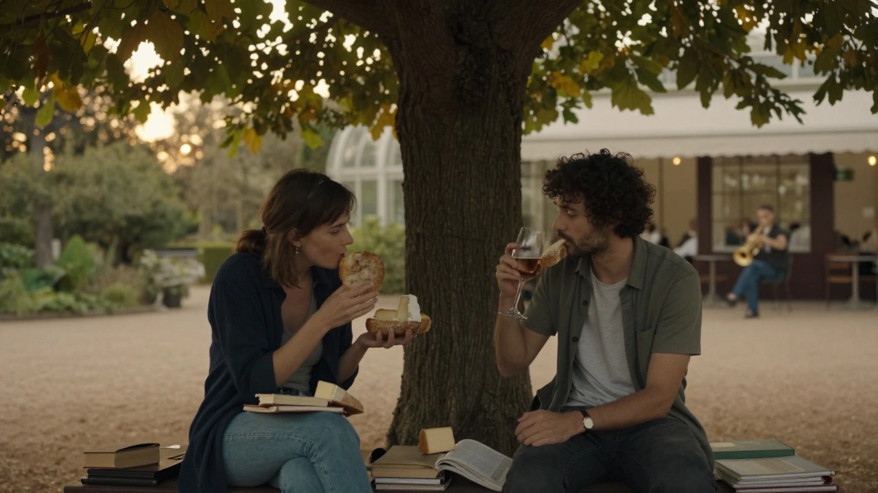Two people sharing food and wine on a bench in Montpellier&#039;s garden at dawn, books nearby, quiet connection.